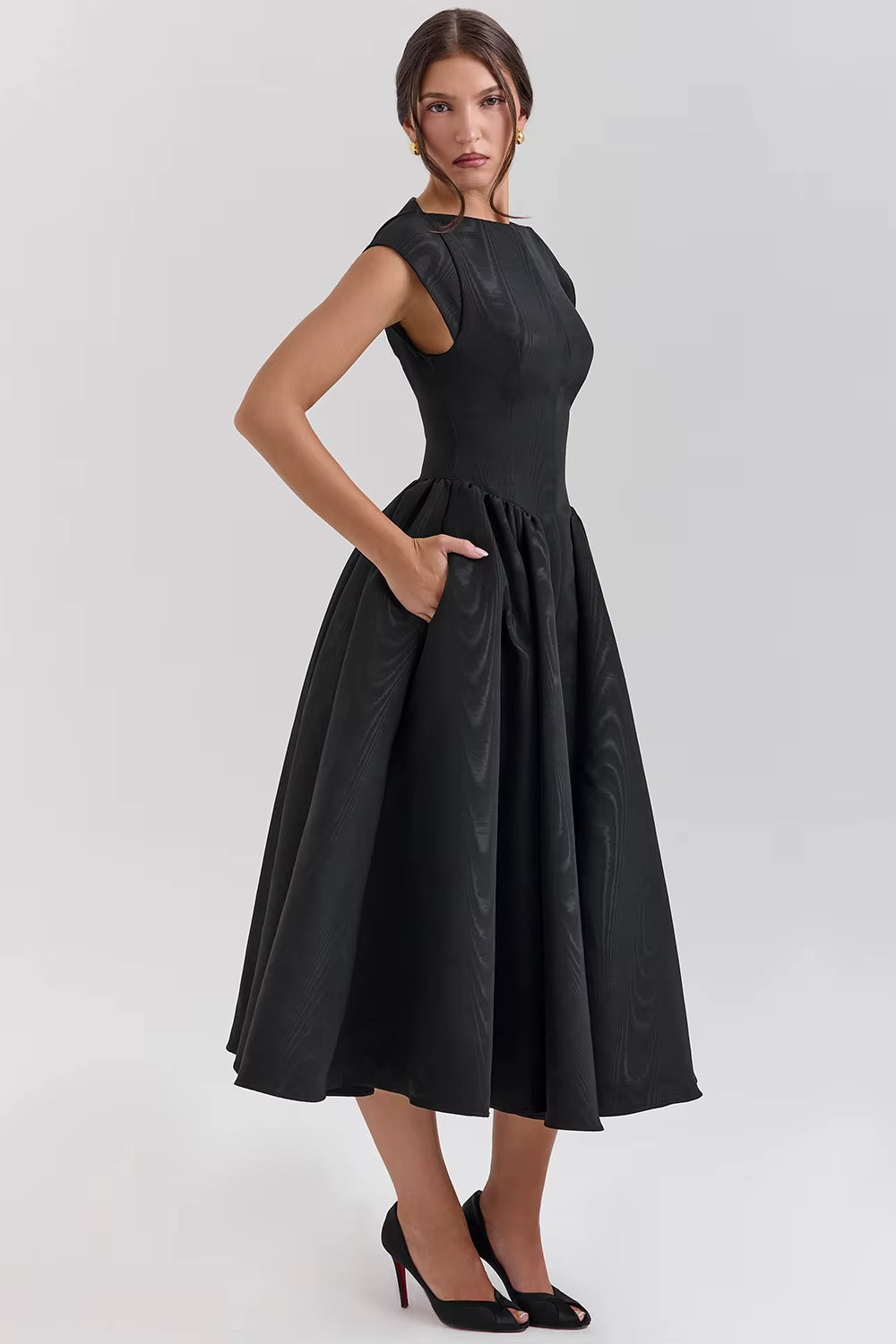 Woman wearing a black dress on a white background