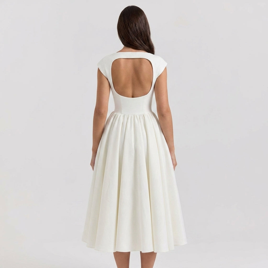 Woman wearing a white dress with a cut-out back on a light gray background