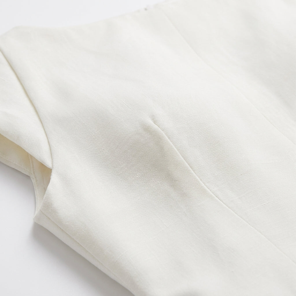 Close-up of a white fabric with folds on a light gray background