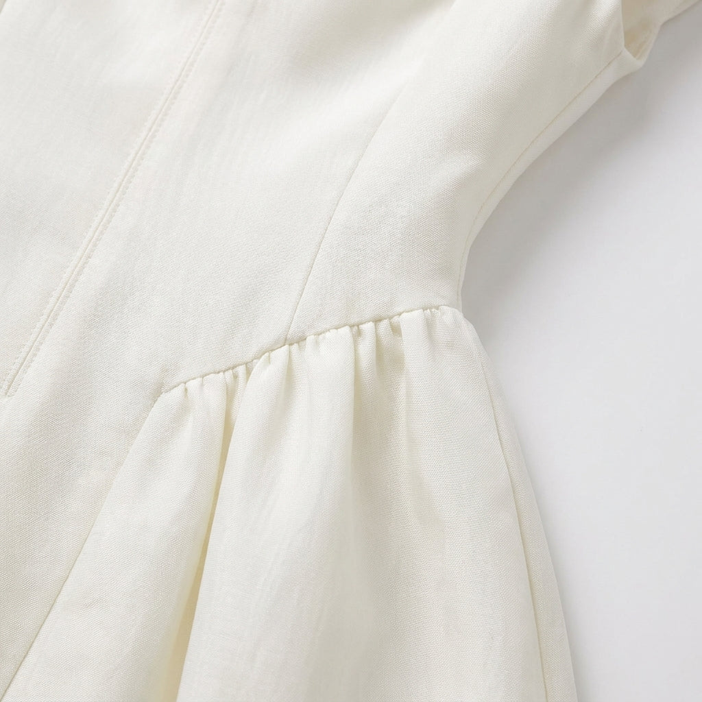 Close-up of a white garment with a focus on the fabric texture.