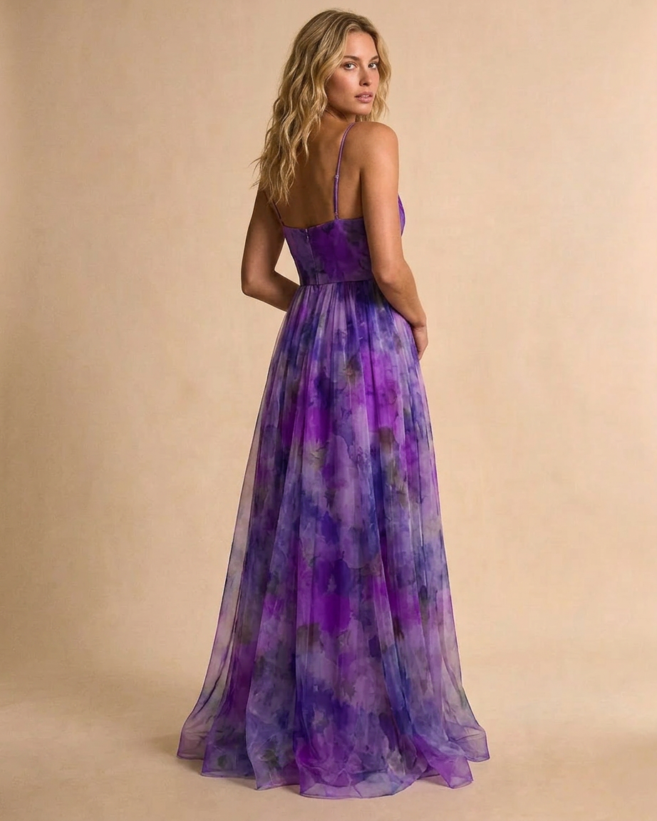 Woman wearing a purple floral dress against a beige background