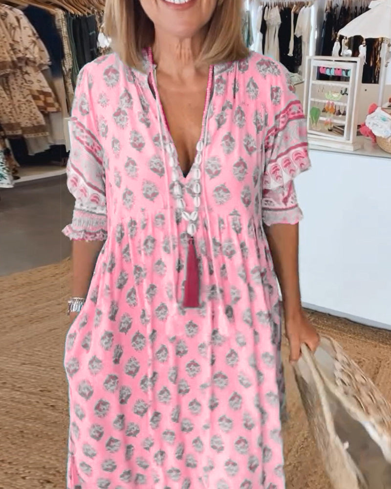 Woman wearing a pink floral dress in a clothing store