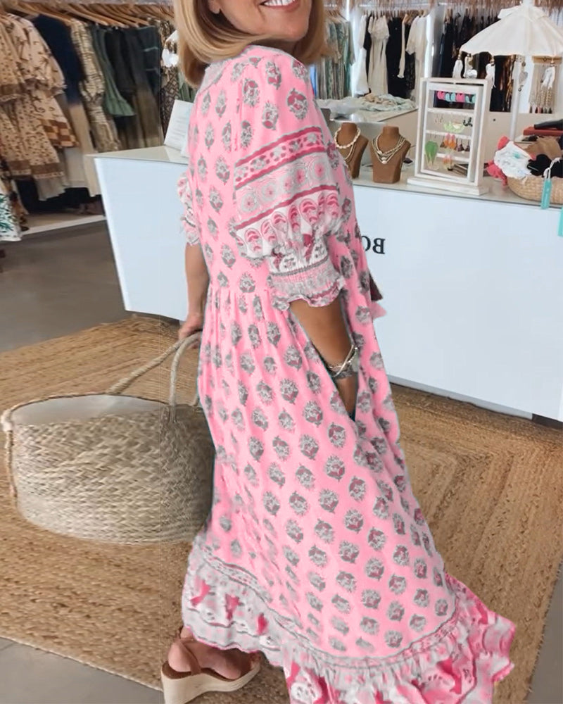 Woman wearing a pink floral dress in a clothing store.