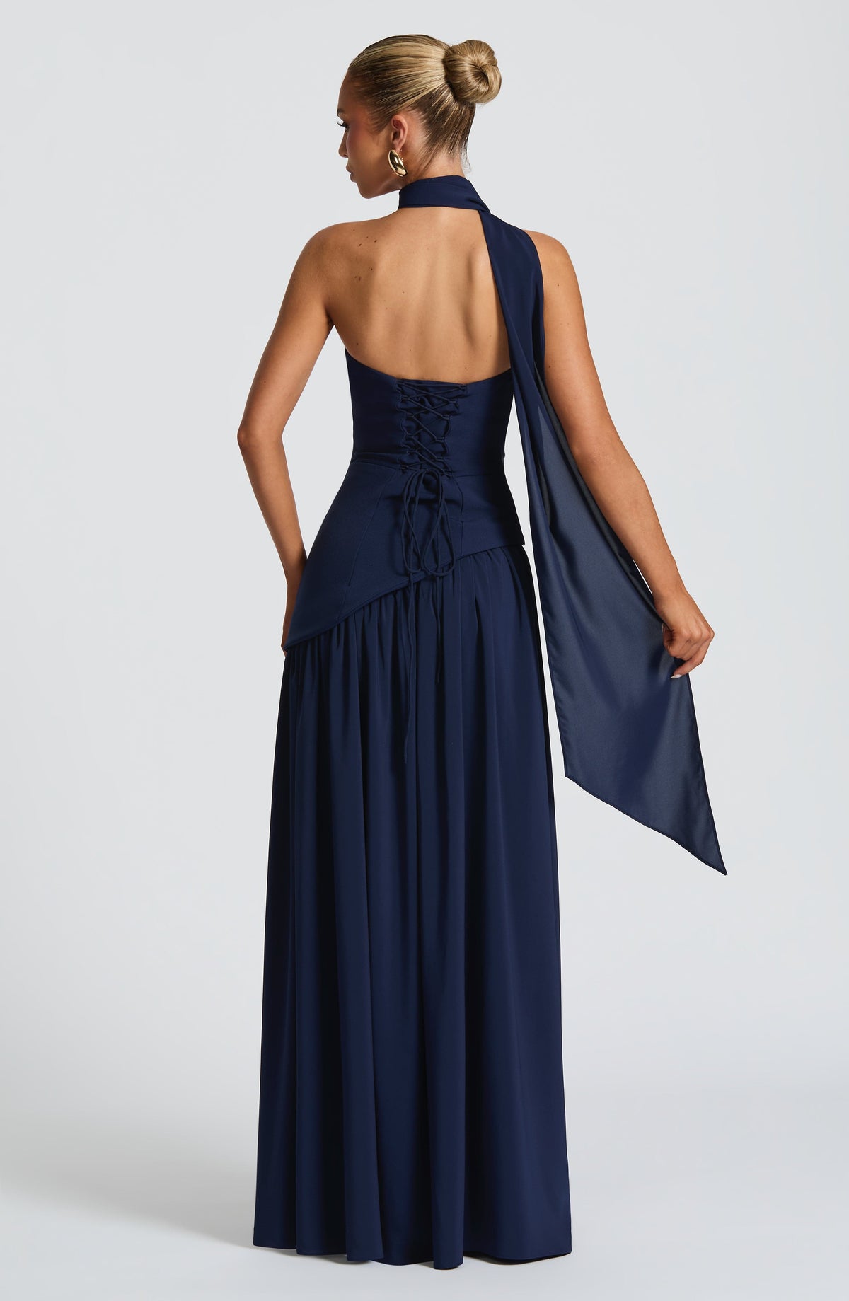 Navy blue evening gown with a cape on a white background
