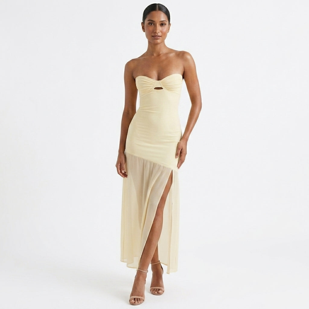 Woman wearing a strapless, light-colored evening gown on a white background