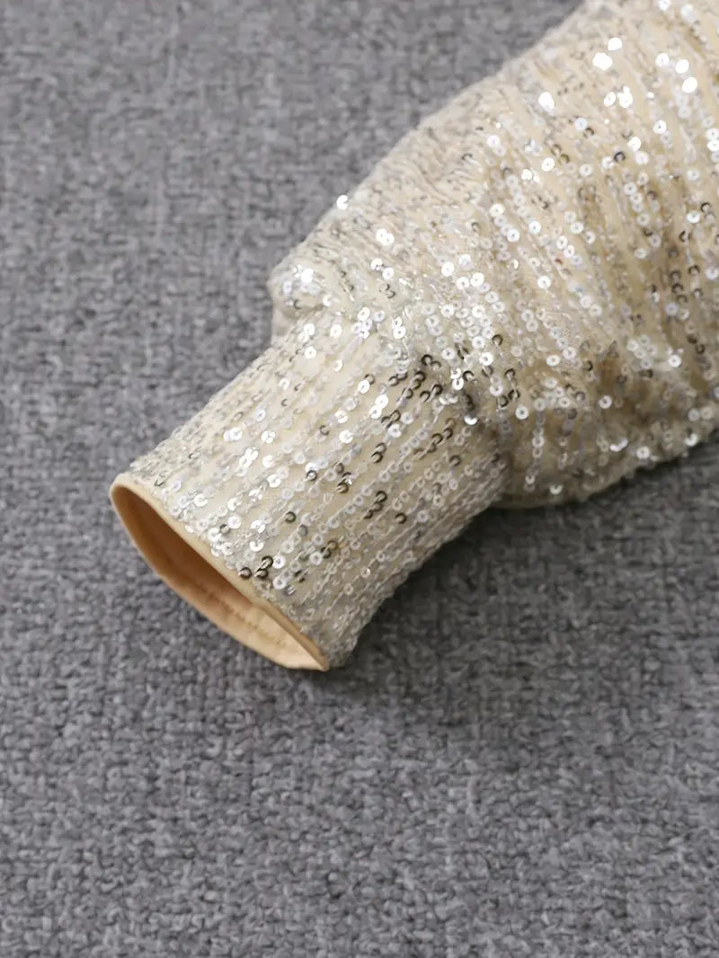 Roll of glittery fabric on a gray surface