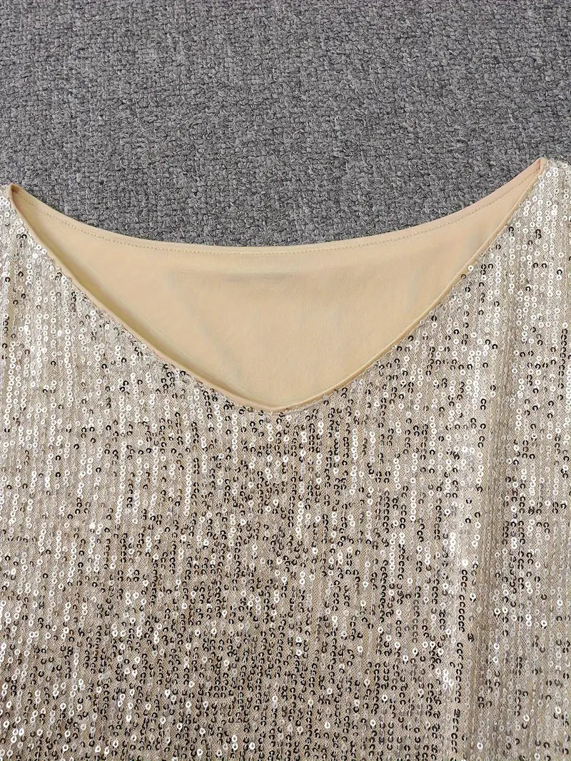 Close-up of a beige sequined garment against a gray textured background