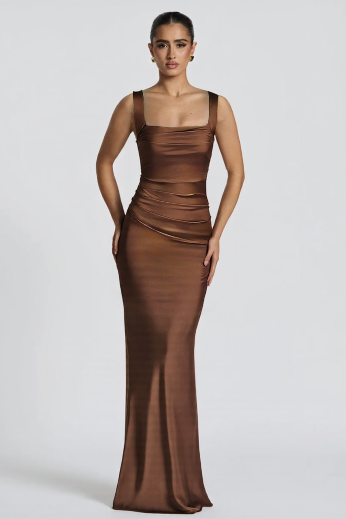 Woman wearing a brown evening gown on a white background