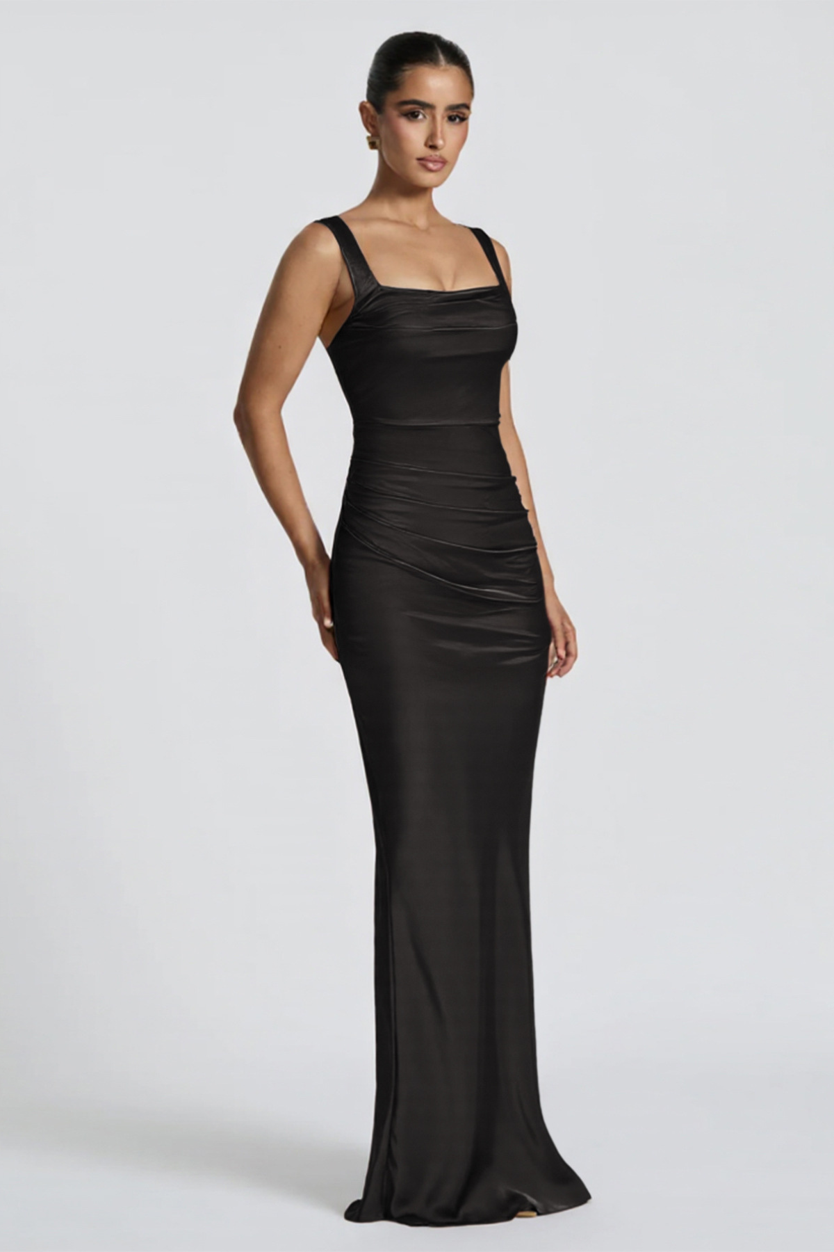 Woman wearing a black evening gown on a white background